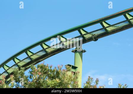 A roller coaster track painted in green view from below Stock Photo