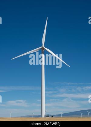 Vertical close up of wind turbine in a wind farm near Judith Gap, MT, with additional windmills in the distance. Stock Photo