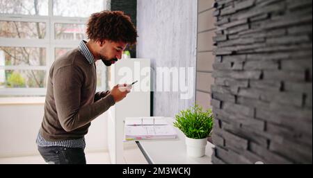 Stealing Trade Secret. Taking Photo Using Phone In Office Stock Photo