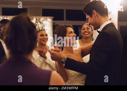I just couldnt have married anyone else. an affectionate young newlywed couple dancing in front of their guests at their wedding reception. Stock Photo
