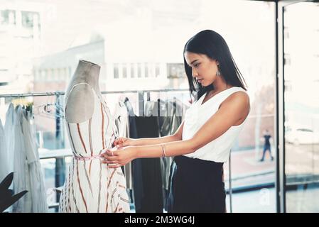 This should be a perfect fit for my client. a successful young fashion designer working on her latest design. Stock Photo