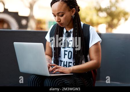 Blogging is a lifestyle. an attractive young woman using a laptop while relaxing outdoors. Stock Photo