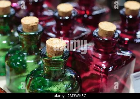 Background with empty colored glass bottles, green and red. Photo with soft focus Stock Photo