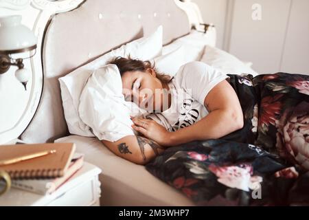 For when she wakes up, shell conquer the world. a beautiful young woman sleeping in her bed. Stock Photo