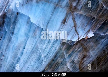 Beautiful landscape of Blue ice cave wall texture at mountains against blue sky in Almaty, Kazakhstan Stock Photo