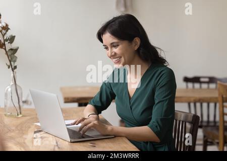 Happy excited freelancer woman working at computer in home office Stock Photo