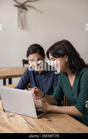 Happy business colleagues women talking on video call together Stock Photo