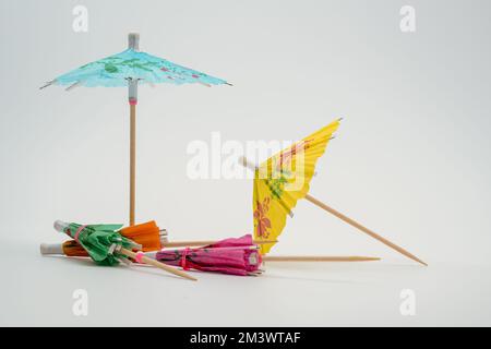 putting up the parasols umbrellas isolated on a white background Stock Photo