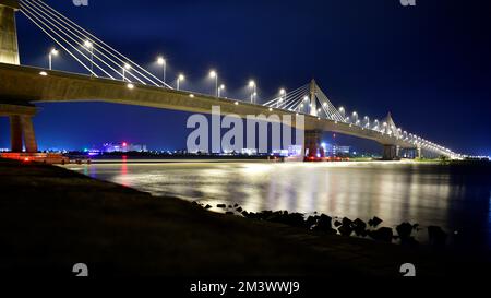 Iconic Payra bridge illuminates at night over River Payra in Bangladesh Stock Photo