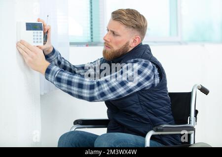 engineer repairman on wheelchair working Stock Photo