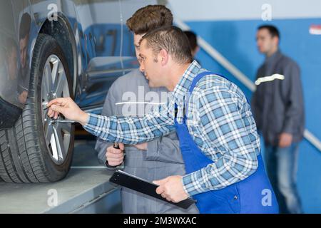 picture of mechanics inspecting wheel bolts Stock Photo