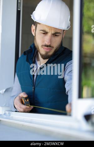 man measuring window Stock Photo