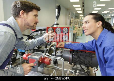 teal of technicians in factory Stock Photo