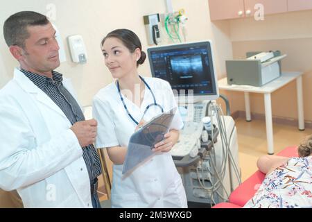 female doctor showing x-ray to her colleague Stock Photo