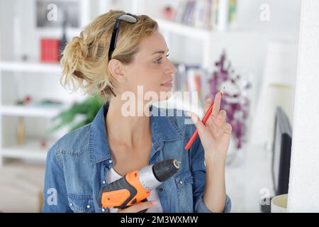 woman using cordless drill for diy project Stock Photo