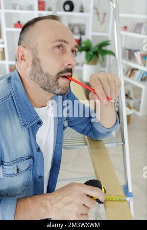 man is thinking about something with pencil Stock Photo