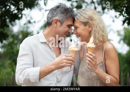 happy old couple eating ice-cream outdoor Stock Photo