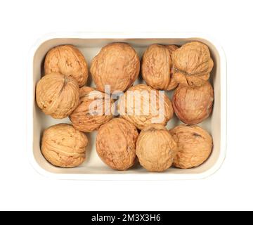 ripe walnuts in a bowl on a white background Stock Photo