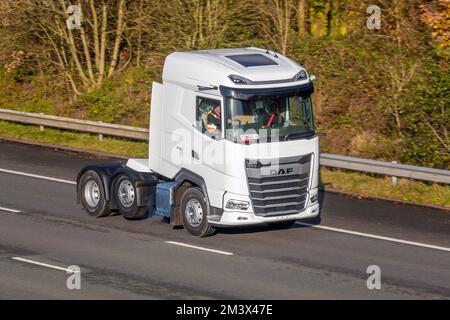 New White DAF 480 XG Tractor Unit, with non-steering mid-lift axle driving with trade plates in Leyland, UK Stock Photo