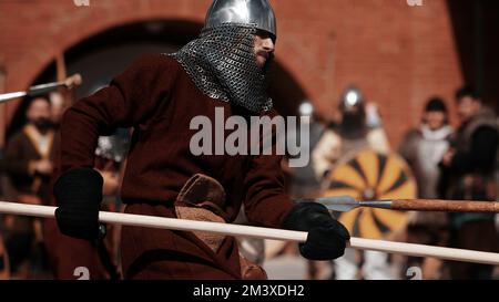 Warrior with a spear in medieval dress. Warrior of medieval Europe. Medieval battle - Historical reconstruction. Medieval tournament. 14.05,2022 Stock Photo