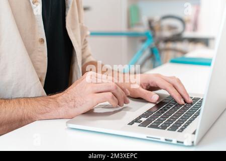 Unrecognizable man employee working on laptop at desk office, cropped image man typing on computer  Stock Photo