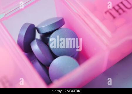 close up of blue color medical pills in a pill box  Stock Photo