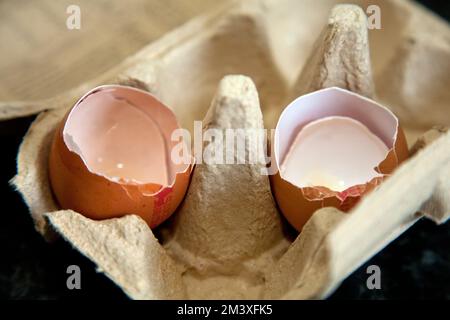 Two empty egg shells in the egg tray Stock Photo