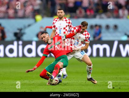 Morocco's Hakim Ziyech (left) and Croatia's Mislav Orsic battle for the ball during the FIFA World Cup third place play-off match at the Khalifa International Stadium, Doha. Picture date: Saturday December 17, 2022. Stock Photo