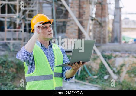 American engineer builder work in construction site. Professional foreman worker project designer leader male. Stock Photo
