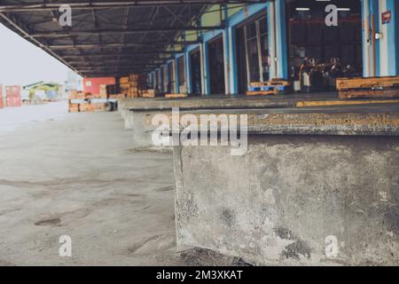 truck shipping docks or cargo loading area at large warehouse building Stock Photo