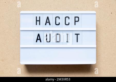 Lightbox with word HACCP (Hazard Analysis Critical Control Points) audit on wood background Stock Photo
