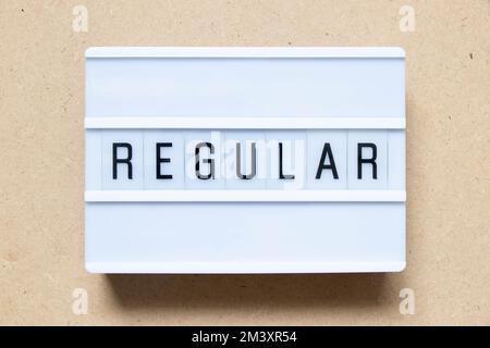 Lightbox with word regular on wood background Stock Photo