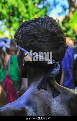 Head of a youHead of a young boy, smeared with black paintng boy, smeared with black paint Stock Photo