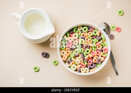 Bowl of colorful corn rings with milk for breakfast. Stock Photo