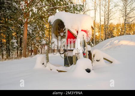 Snow cannon gun or machine sprays water and snowes a ski or cross-country  track Stock Photo - Alamy