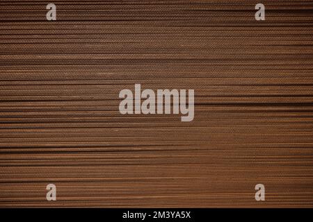 Corrugated cardboard. A stack of corrugated cardboard for packing. Background of Corrugated Brown Cardboard. Second life of paper, recycled material Stock Photo