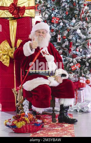 Authentic Santa Claus with big red bag full of gifts on sea background ...