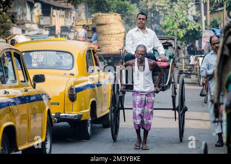 Hand pulled rikshaws are still common in the streets Stock Photo