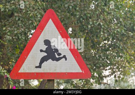 Traffic sign showing a running person, advice how to cross the road Stock Photo