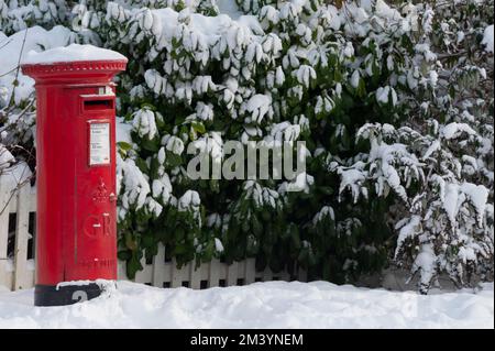A pillar box post box on a snowy winter’s day in Oxford. Stock Photo