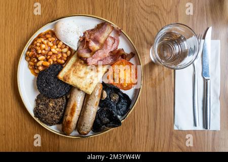Overhead view of traditional Scottish breakfast with haggis, ham, sausages, mushroom, baked beans Stock Photo