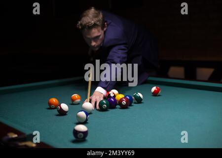 Medium shot guy suit playing game, Billiards Stock Photo