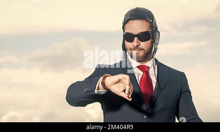 businessman in suit and pilot hat check time Stock Photo