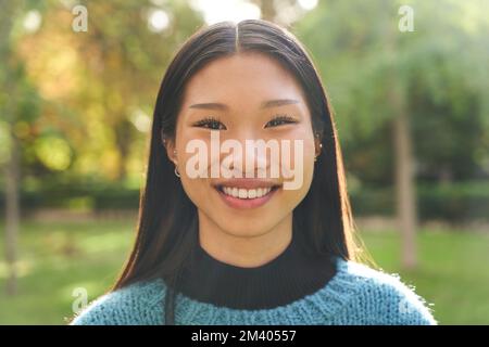 Happy smiling young Asian girl in sportswear sports cap and pink