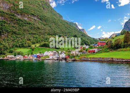 Undredal seen from the sea. It is a picturesque tiny village that sits along the Aurlandsfjord, Vestland county, Norway and it is a popular tourist de Stock Photo