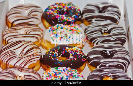 dozen donuts of different flavors, colors and textures Stock Photo