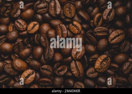 Coffee beans roasted full frame background Close up macro dark brown Stock Photo