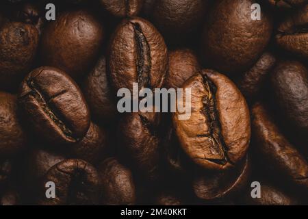 Coffee beans roasted full frame background Close up macro dark brown Stock Photo