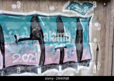 Graffiti blue, pink, purple words, written letters ARCHI. Graphic design made in a chaotic way when a paint can be washed on a concrete fence... Stock Photo