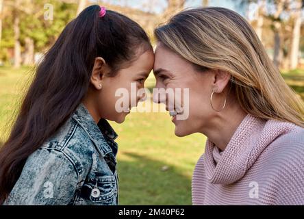 My little girl, my first love. an adorable little girl spending quality time with her mother at the park. Stock Photo